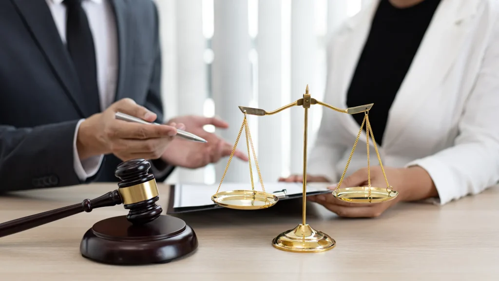 Legal consultation with a scale, gavel, and documents on the table